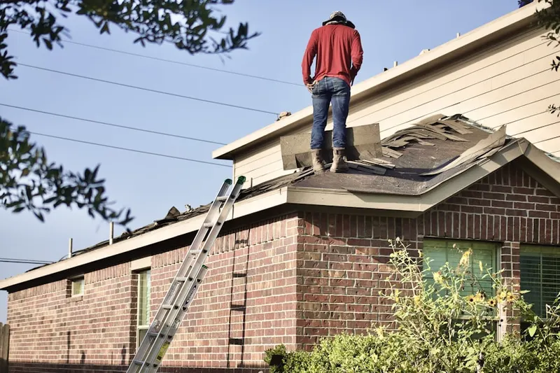 Professional roofer working on a residential roof in Kingsridge